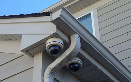 two cctv cameras installed on a house