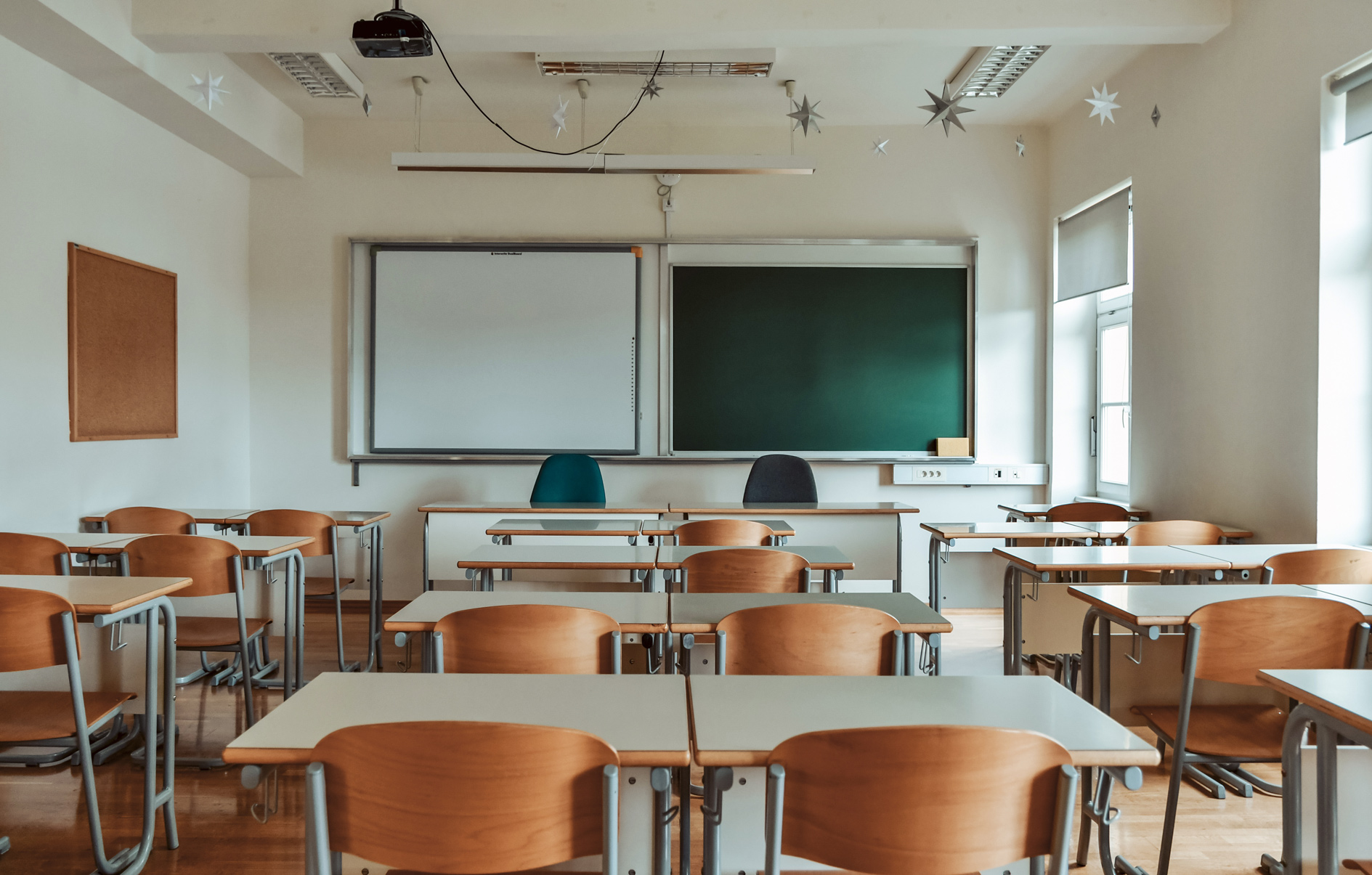 School classroom with desks and green chalkboard