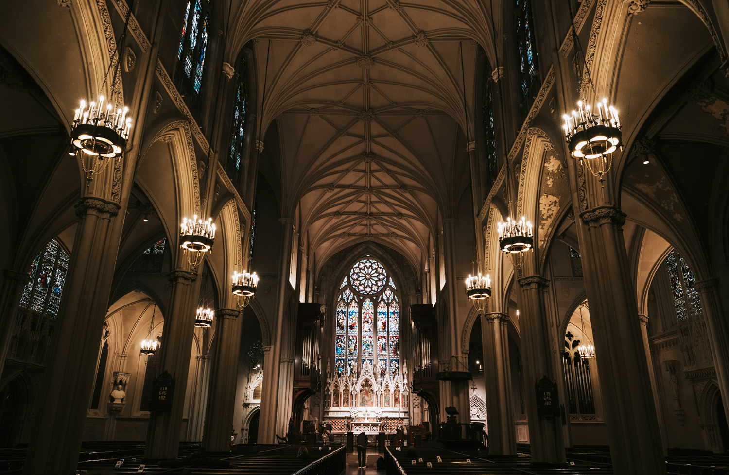 Church sanctuary with stained glass windows and interior lighting